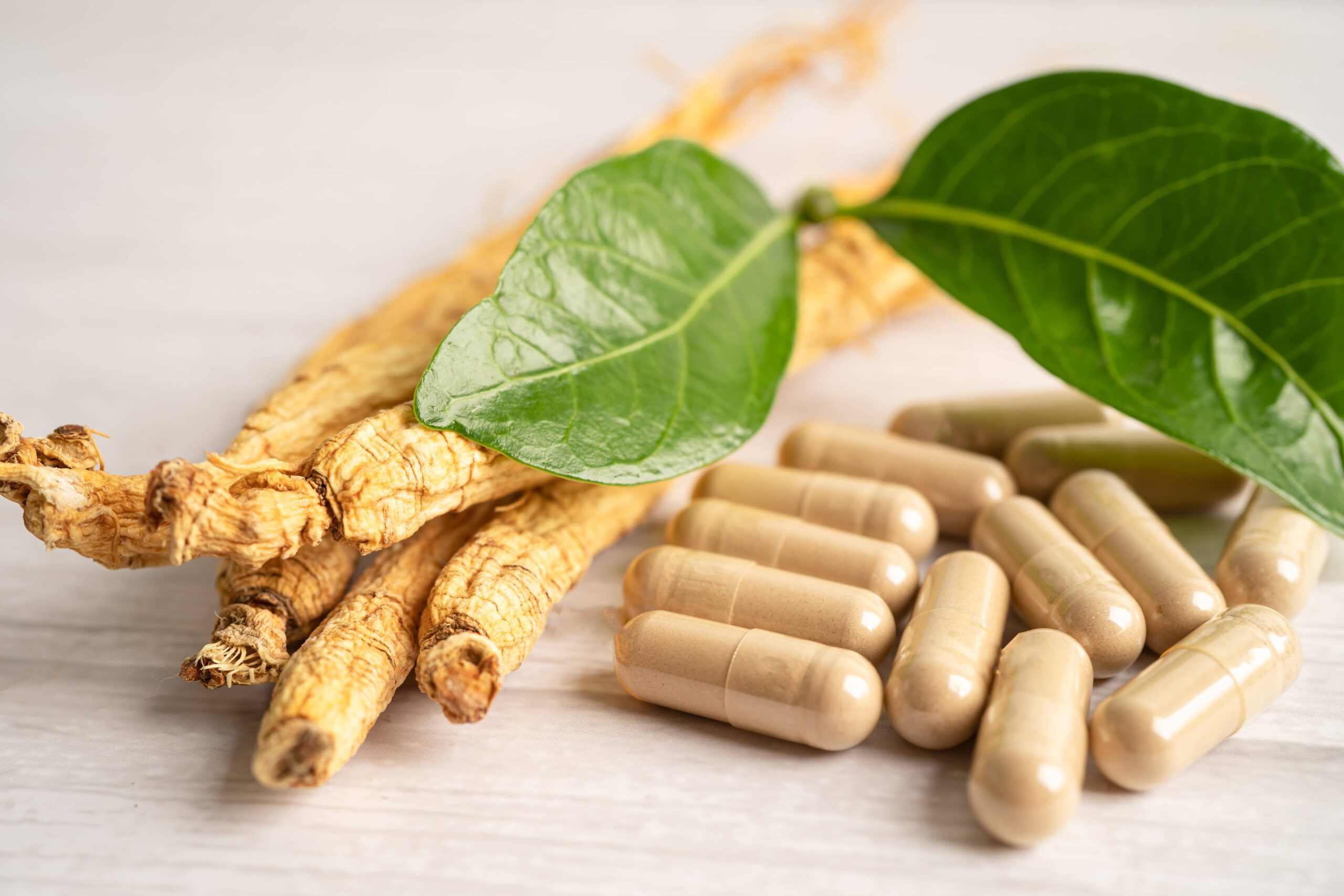 Asian ginseng root and capsules Panax ginseng showing warming effects and energy boosting properties